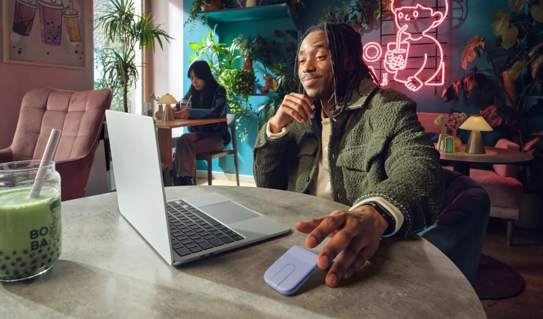 person-browsing-internet-with-mobi-fold-lilac-in-a-cafe-additional-feature-2
